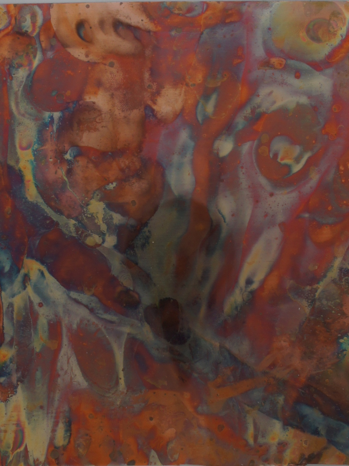 Red and rust colored painting on copper