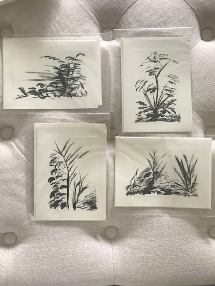 Four handmade greeting cards with charcoal drawings of plants