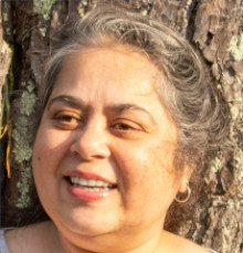 Mitali Chakraborty face with tree bark in background